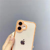 A hand holds a clear phone case with an orange rim and dual camera lenses on the back, featuring an Apple logo.