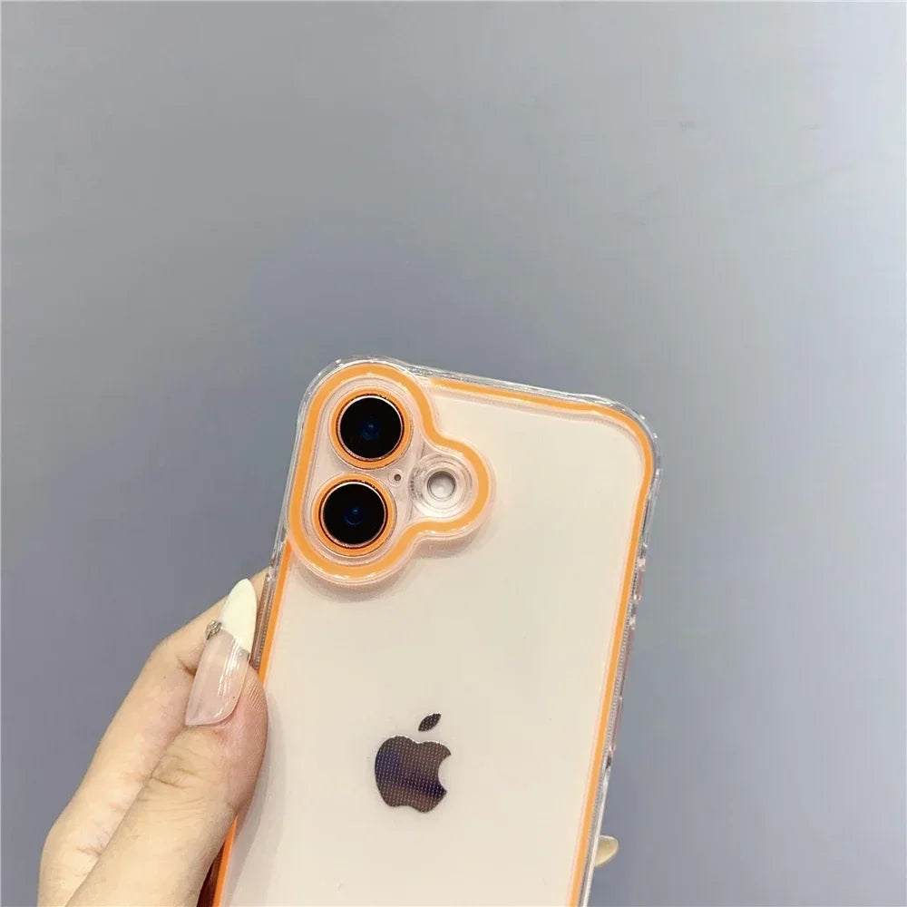 A hand holds a clear phone case with an orange rim and dual camera lenses on the back, featuring an Apple logo.