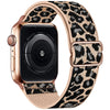 A close-up of a rose gold Apple Watch with a leopard print nylon band.