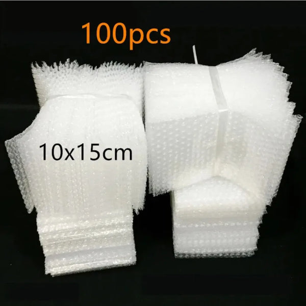 A pair of white clear plastic bubble mailer shipping bags, measuring 10x15 cm each.