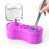 A hand is using a blue paint brush to clean a clear glass bottle within a pink plastic cleaning set.
