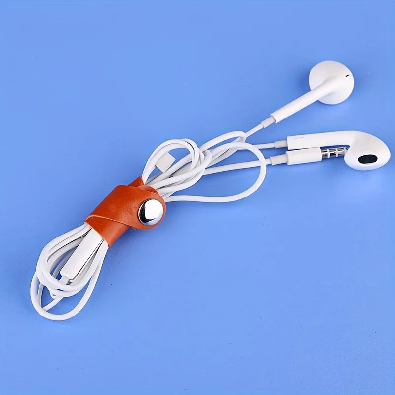 A white faux leather data cable with earphones is displayed on a blue background.