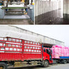 A red flatbed truck is loaded with numerous white and pink bubble wrap rolls for cushioning packaging.