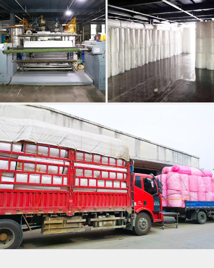 A red flatbed truck is loaded with numerous white and pink bubble wrap rolls for cushioning packaging.
