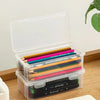 Clear storage box with lid filled with colored pencils and art supplies