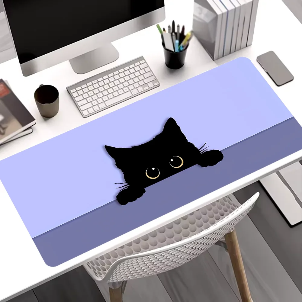 A black cat silhouette is printed on a purple mouse pad placed on a white desk.