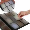 A hand is placing a sheet of gray card stock into a black binder album for a large capacity card binder.