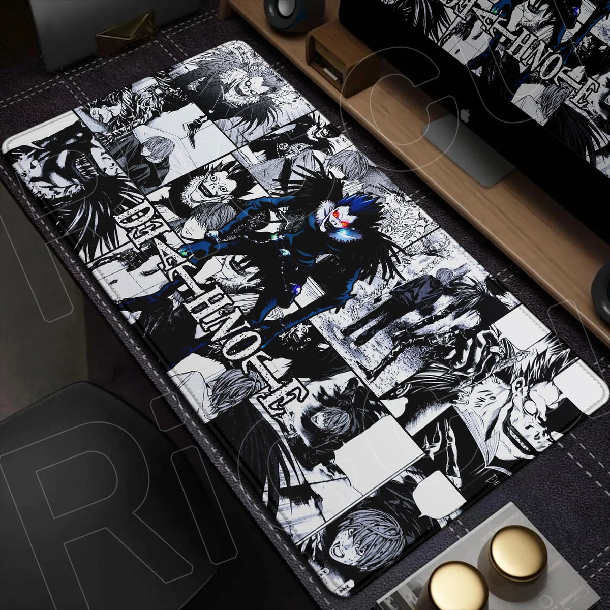 An oversized black and white graphic mouse pad featuring Death Note characters and themes on a wooden desk surface.