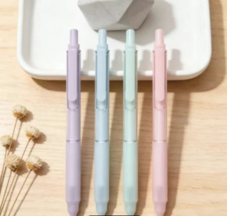A pack of four pastel gradient gel pens in lavender, mint green, and pink are displayed on a white tray.