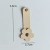 A beige leather flower cable organizer with a loop and a flower shape, measuring 9.8cm by 3.7cm.