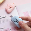 A hand holds a light blue utility knife, positioned above a recipe ingredient list.
