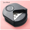 A black precision corner cutter tool with a hinged blade is shown against a light pink background.