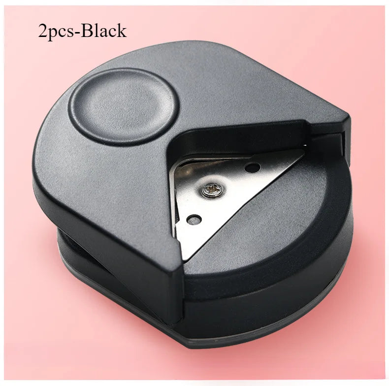 A black precision corner cutter tool with a hinged blade is shown against a light pink background.