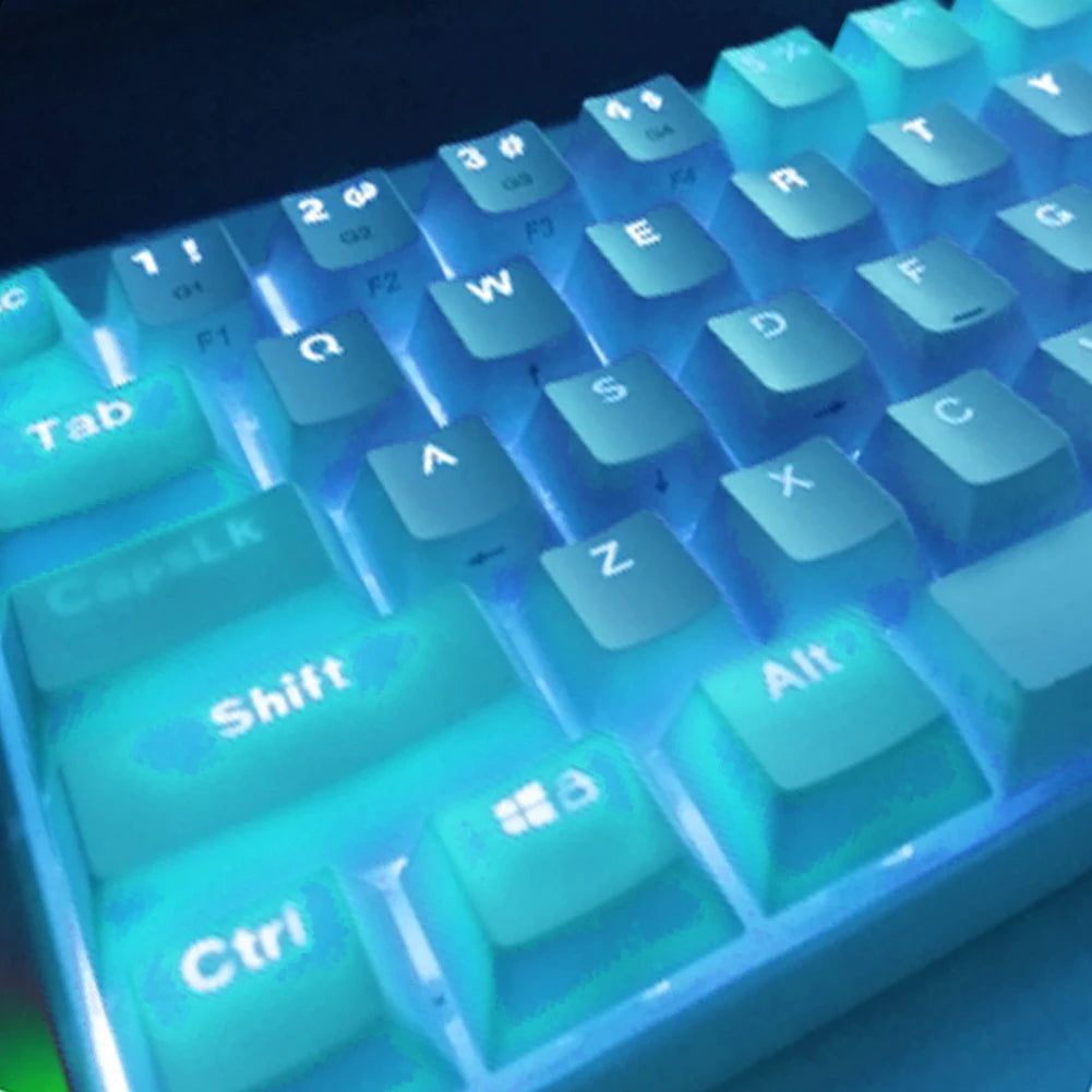 Close-up view of a light blue backlit mechanical keyboard keycaps showing letters and function keys.