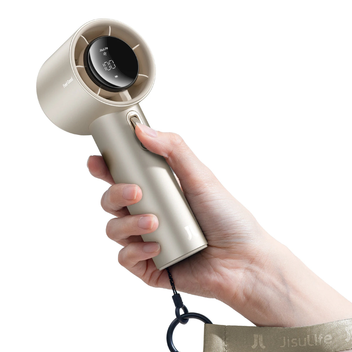 A hand holds a beige handheld fan with an LED display, showing the fan in use.