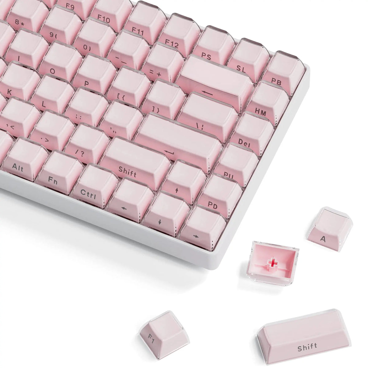 A close-up view of pink translucent ice crystal mechanical keycaps arranged on a white keyboard, with spare keycaps visible.