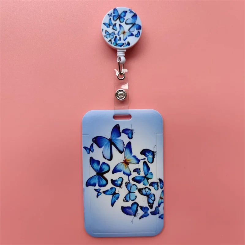 A light blue card holder clip featuring a design of blue butterflies on the surface.