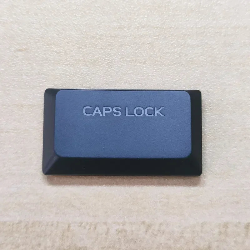 A dark blue caps lock keycap for a keyboard, labeled CAPS LOCK.