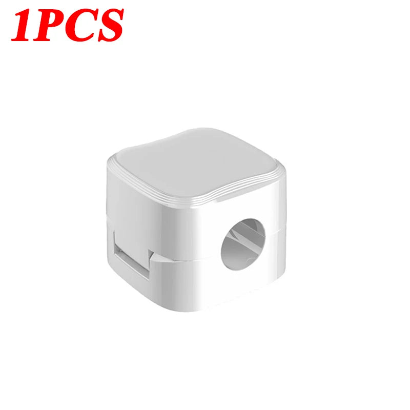 A single white magnetic cable clip designed for desk organization.