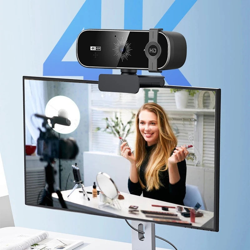 A 4K auto-focus webcam is mounted on a monitor, showing a smiling woman in the background.
