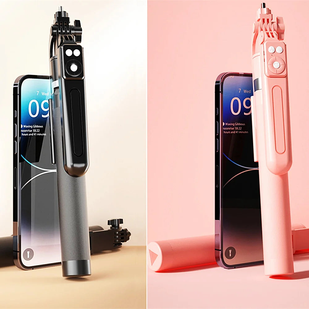 A pink 360 degree rotation selfie stick with a smartphone attached and a Bluetooth remote.