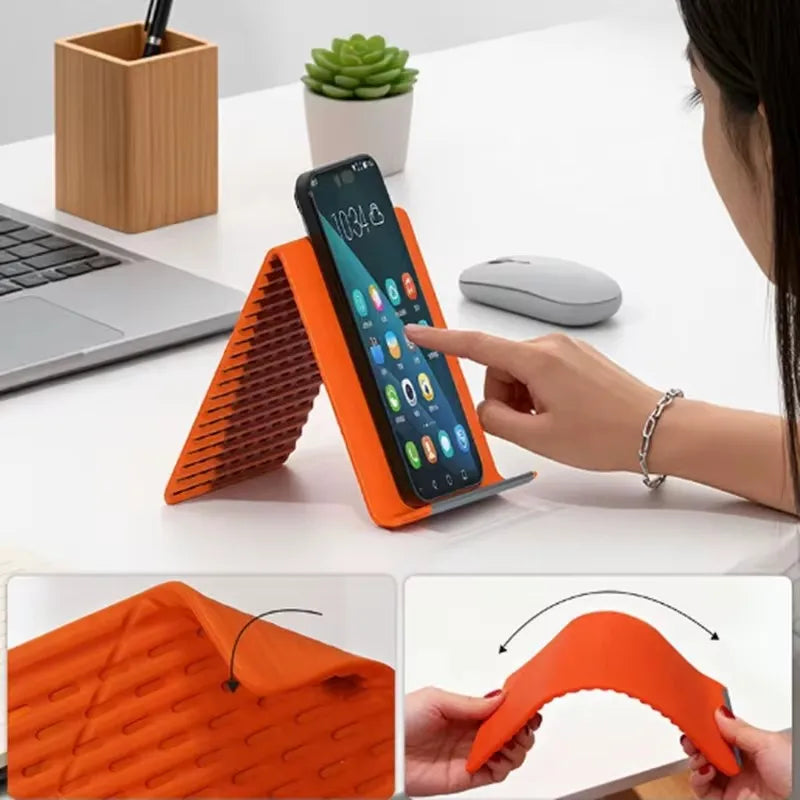 An orange silicone multi-angle stand holding an iPhone, demonstrating its flexible design.