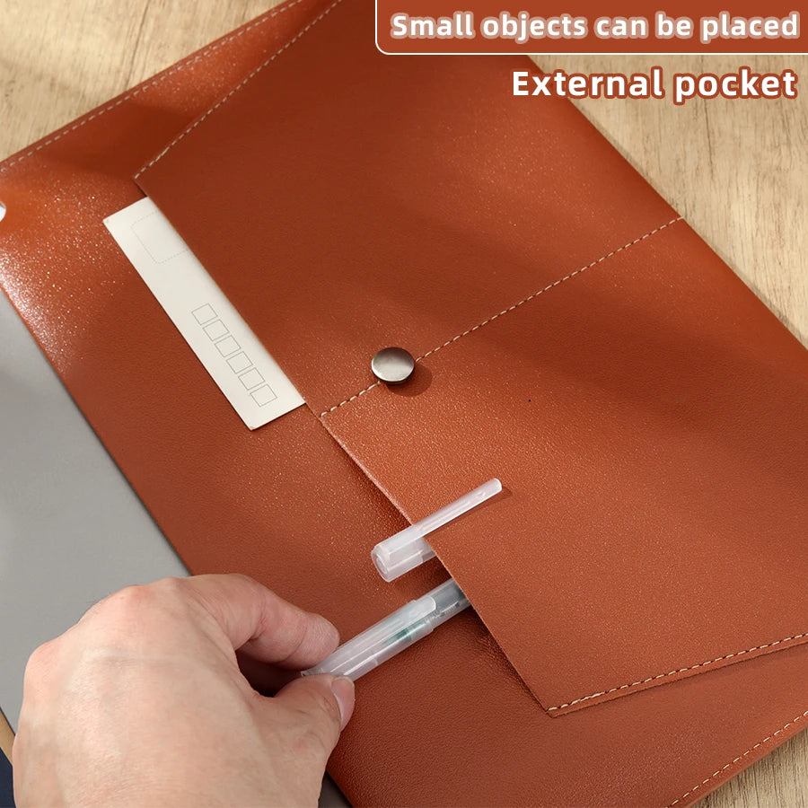 A hand places a white card into the external pocket of a brown leather document organizer bag.