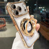 A hand holds an iPhone in a gold magnetic stand case with lens protection and kickstand.