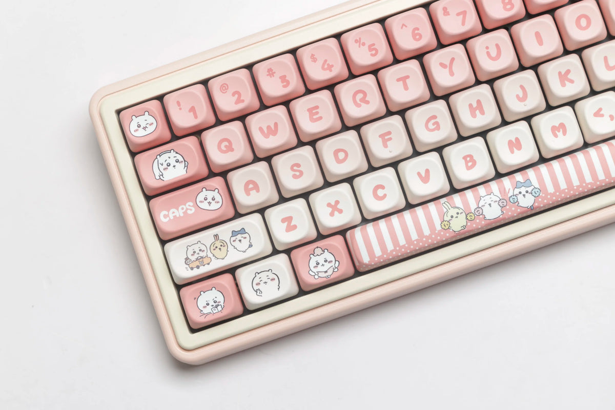 A close-up view of light pink and white themed PBT keycaps for a mechanical keyboard.