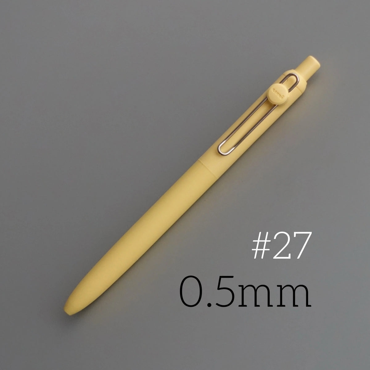 A yellow precision gel pen with a silver clip and a black barrel, shown diagonally on a gray background.