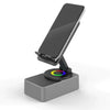 A wireless speaker with an adjustable phone stand and night light resting on a gray base.