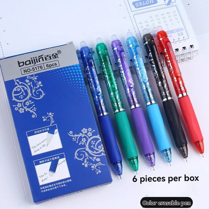 A box containing a set of six black, blue, green, purple, and red erasable retractable gel pens is shown next to a notepad.