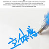 A close-up of a hand writing Korean characters with a blue high-gloss acrylic marker pen on white paper.