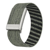 A close-up of a dark green and black striped nylon braided strap for a fitness watch.