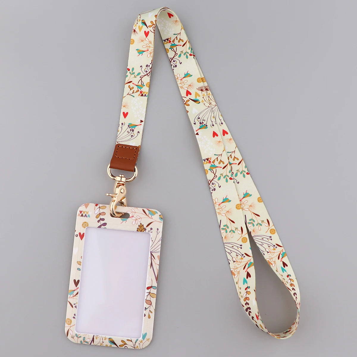 A beige floral patterned fashion lanyard strap with a rectangular ID badge holder attached.
