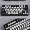 A close-up view of a black mechanical keyboard featuring transparent pudding style PBT keycaps for CSGO gaming.