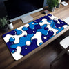 Blue wave art non-slip mouse pad featuring white and blue abstract blobs on a wooden desk.