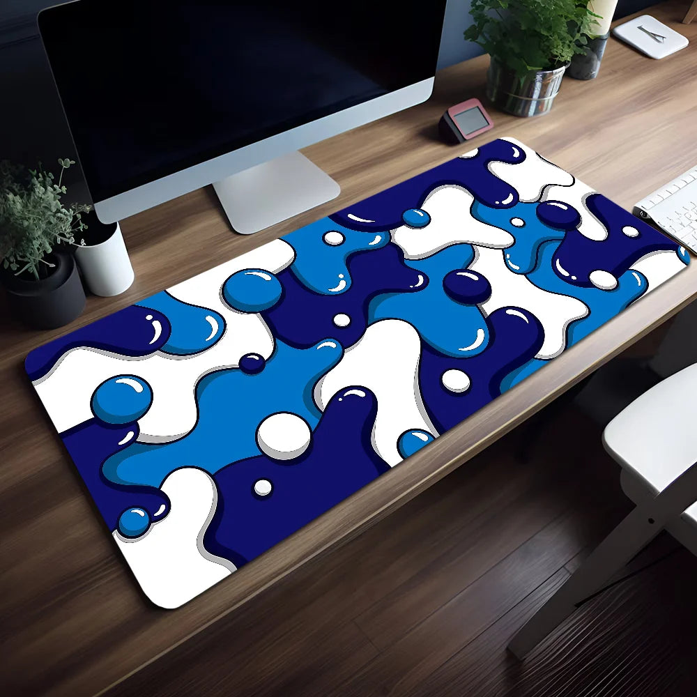 Blue wave art non-slip mouse pad featuring white and blue abstract blobs on a wooden desk.