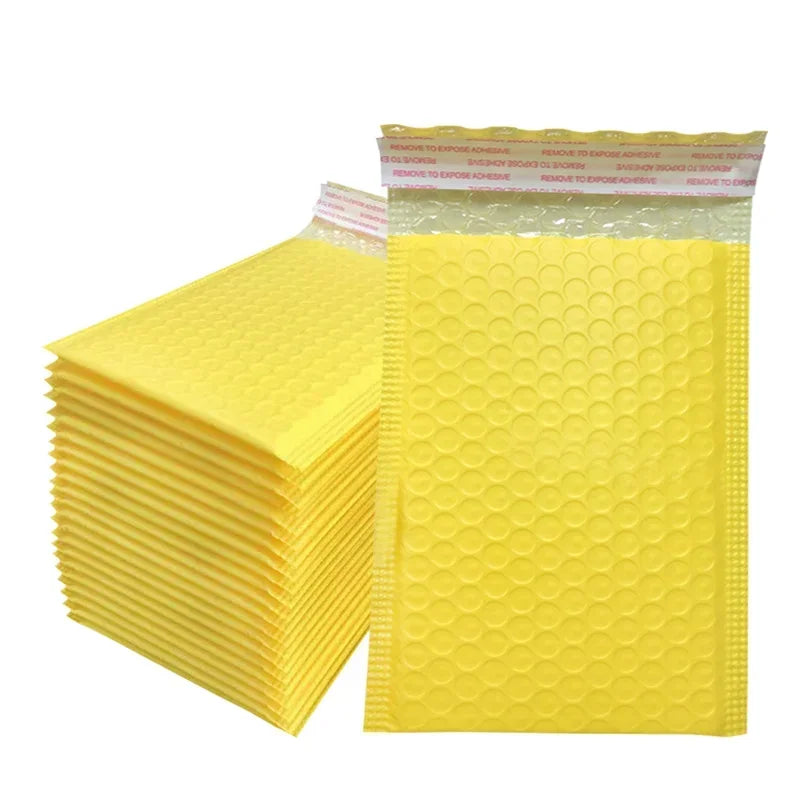 A stack of yellow bubble mailers with self-sealing padded envelopes is shown.