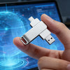A hand holds a silver USB flash drive against a blue digital background on a screen.