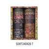 A set of vintage floral washi tape rolls displayed in a wooden box.