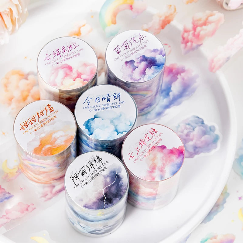 A collection of six rolls of kawaii cloud pattern masking tape in various pastel colors arranged on a white plate.