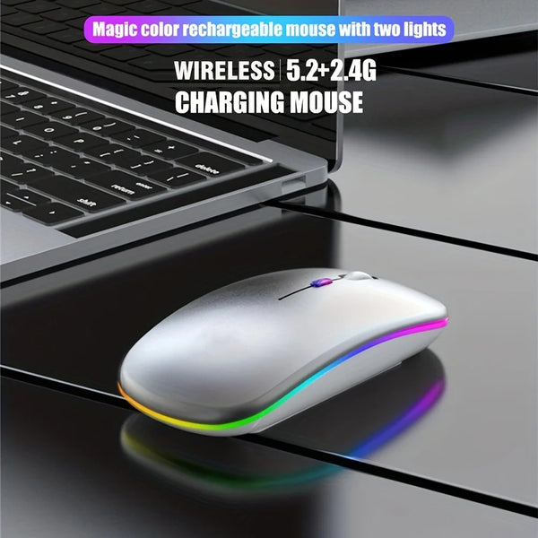 A white wireless gaming mouse with purple and green lights resting on a dark surface next to a laptop keyboard.