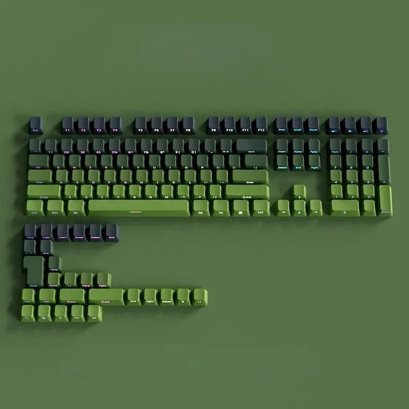 A close-up view of a green mechanical keyboard featuring Gradient Gray double shot PBT keycaps with side printing.