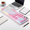 A low profile wired gaming keyboard with a numpad is displayed next to a laptop and notebooks.