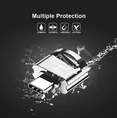 A silver universal Type-C to Micro-SD card reader is shown being splashed by water.