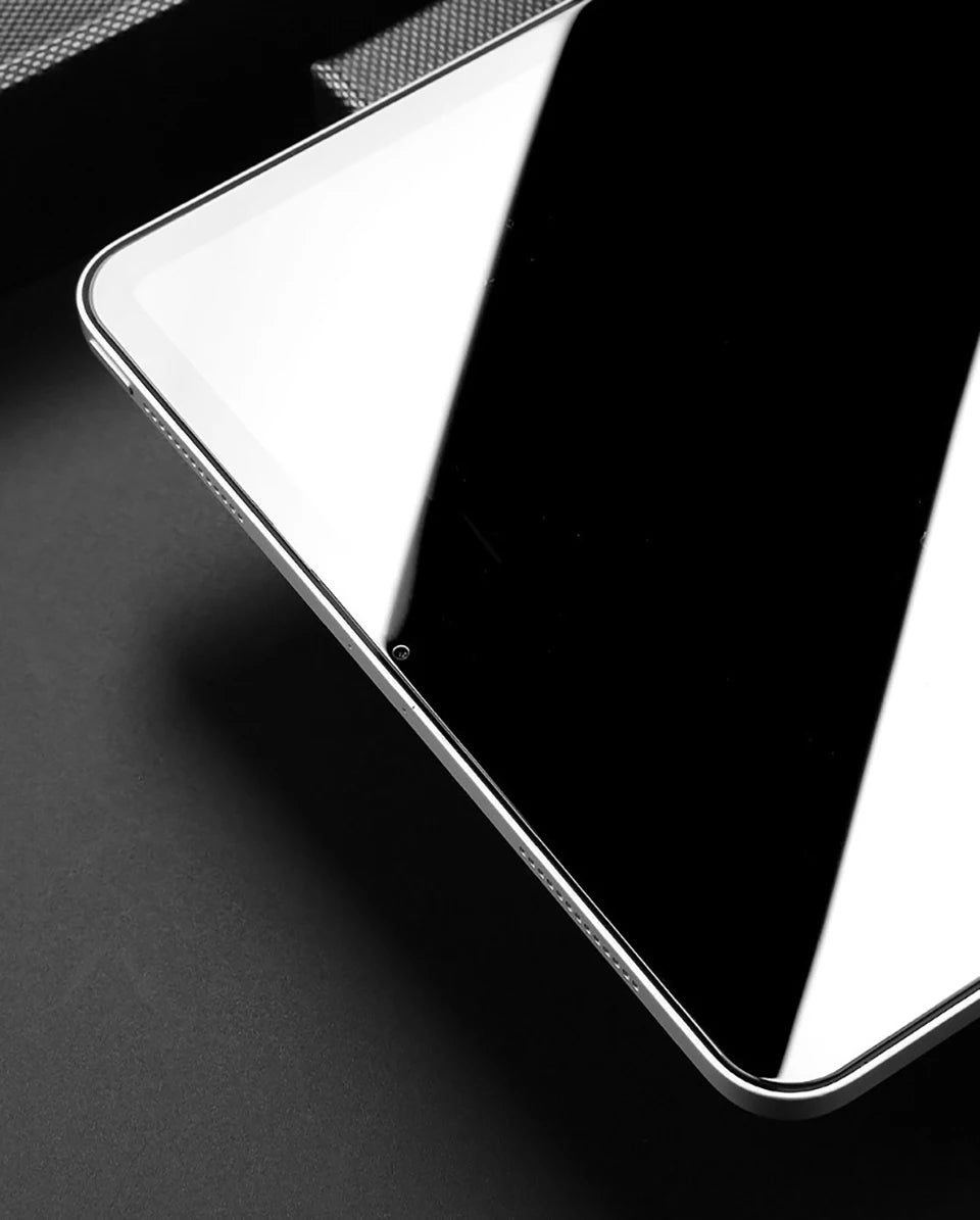 A close-up, angled shot of a black iPad screen with a clear glass protector applied.