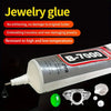 A bottle of B-7000 multi-purpose adhesive jewelry glue with small pieces of silver and white jewelry.