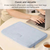 A light blue corduroy inner liner bag laptop sleeve is shown on a desk next to a laptop.
