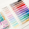A collection of multicolor retractable gel pens in various shades and colors arranged on a white sheet.